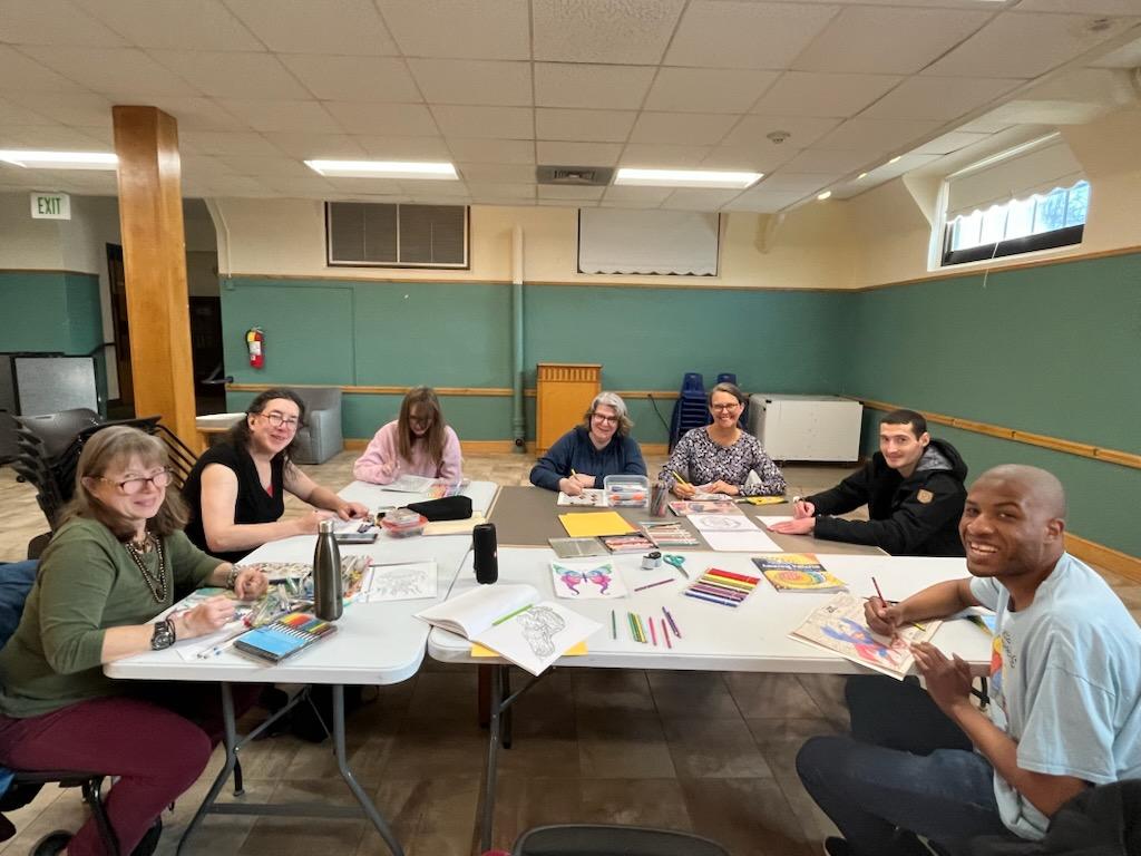 Adults participating in a relaxed coloring party event.